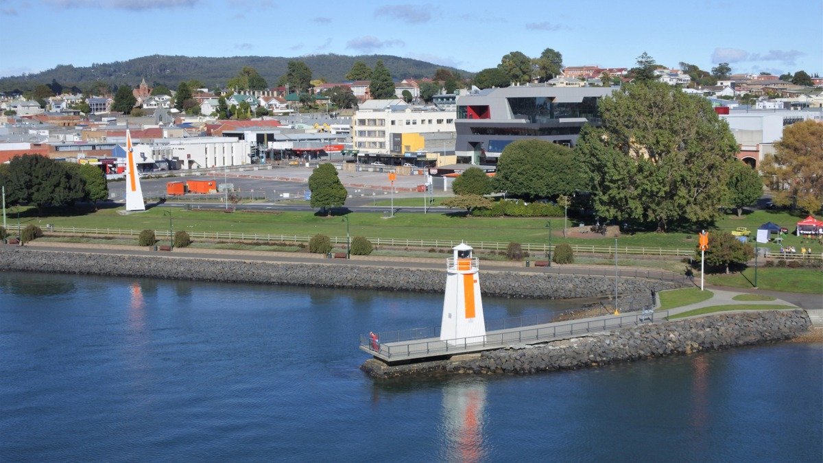 Featured image for Gemboree showing Devonport’s waterfront, the Mersey River, the white beacon with an orange stripe, and the paranaple Convention Centre.